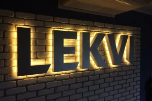 rear halo lit channel letter sign installed on brick wall