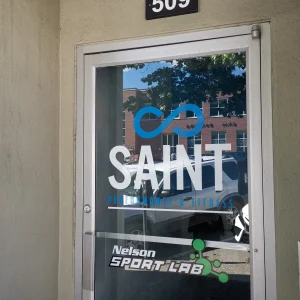 blue and white logo window graphics of a fitness facility on glass door